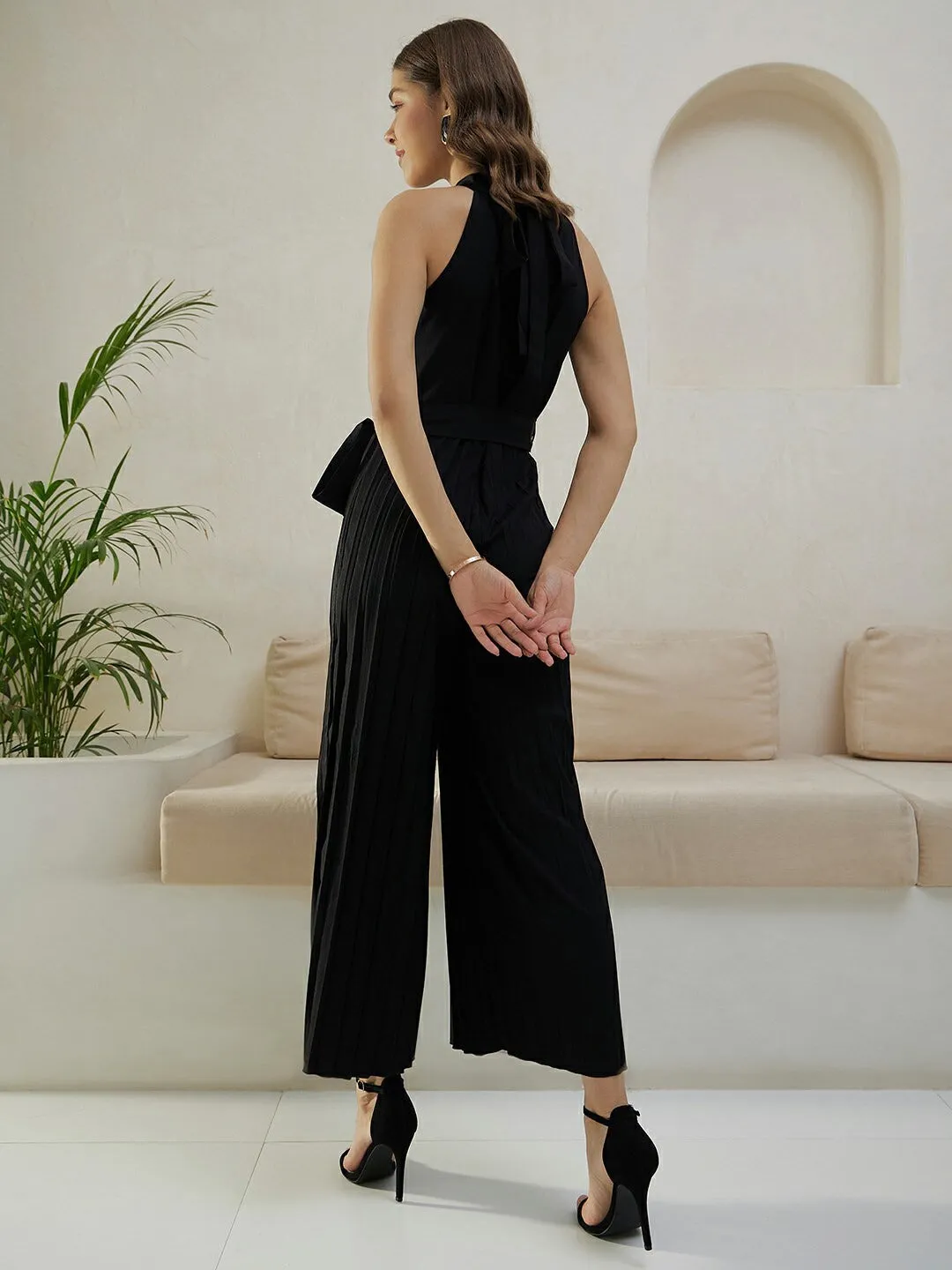 Berrylush Women Solid Black Halter Neck Sleeveless Waist Tie-Up Pleated Culotte Jumpsuit